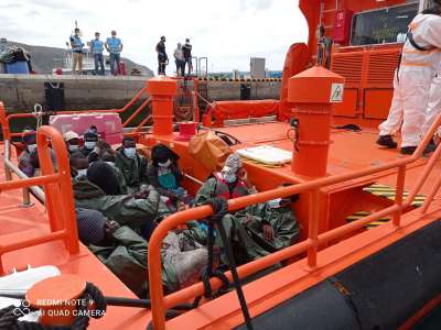 Maritime rescue retrieve sinking cayuco off coast of south of Tenerife