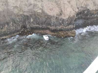 A woman is injured when her car rolls off a cliff and falls 100ft into the sea