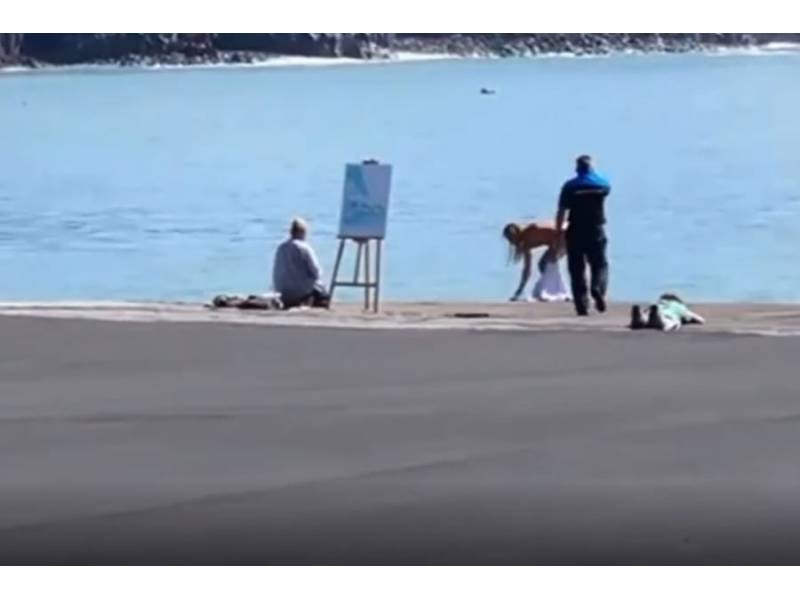 Nude model stopped while posing for a painting in front of the volcano in La Palma