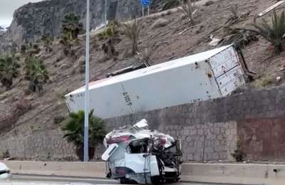 Lorry driver killed as truck veers off road and rolls down a steep hill 