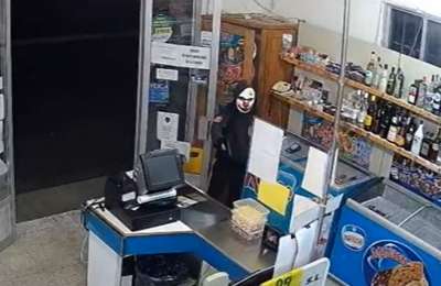 VIDEO: A supermarket is robbed at gunpoint by man wearing a clown mask