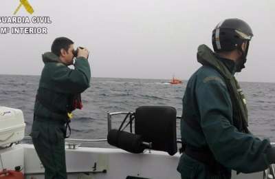 The Guardia Civil rescue two crew members of a capsized catamaran in Tenerife