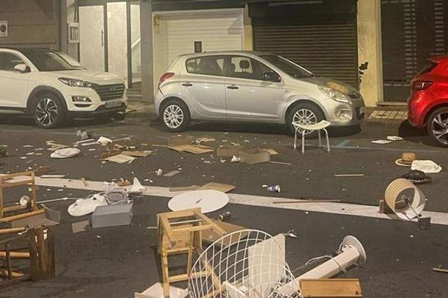 A tourist destroys a holiday home and throws furniture onto the street from a window