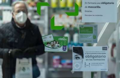 When will face masks be scrapped in hospitals and pharmacies in Spain?