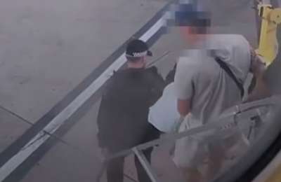 Police escort passenger off plane after he was caught smoking in the toilet