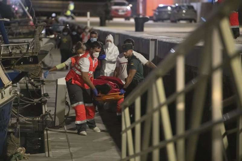 A merchant ship rescues 54 occupants of a small boat that was sinking in the Atlantic