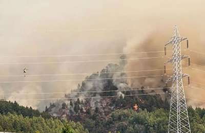 Mountain access roads are being closed and helicopters are helping firefighters