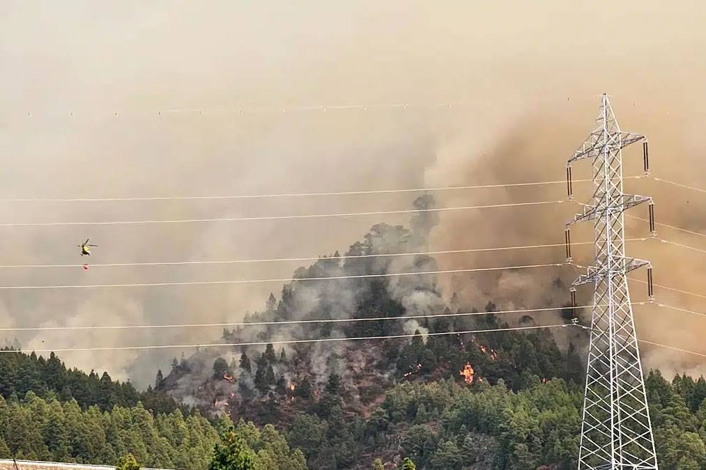 Mountain access roads are being closed and helicopters are helping firefighters