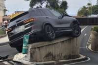 Mystery crash leaves car stuck on a wall