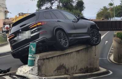 Mystery crash leaves car stuck on a wall