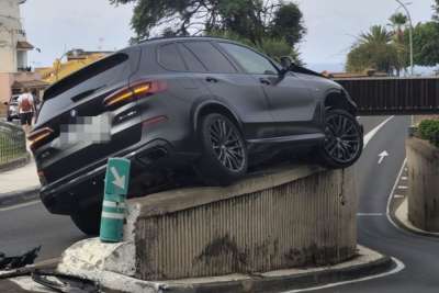 Mystery crash leaves car stuck on a wall