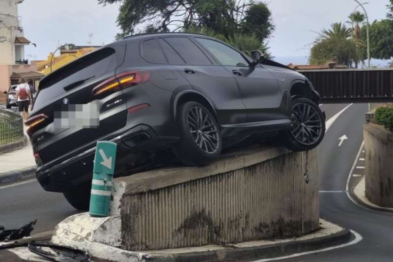 Mystery crash leaves car stuck on a wall